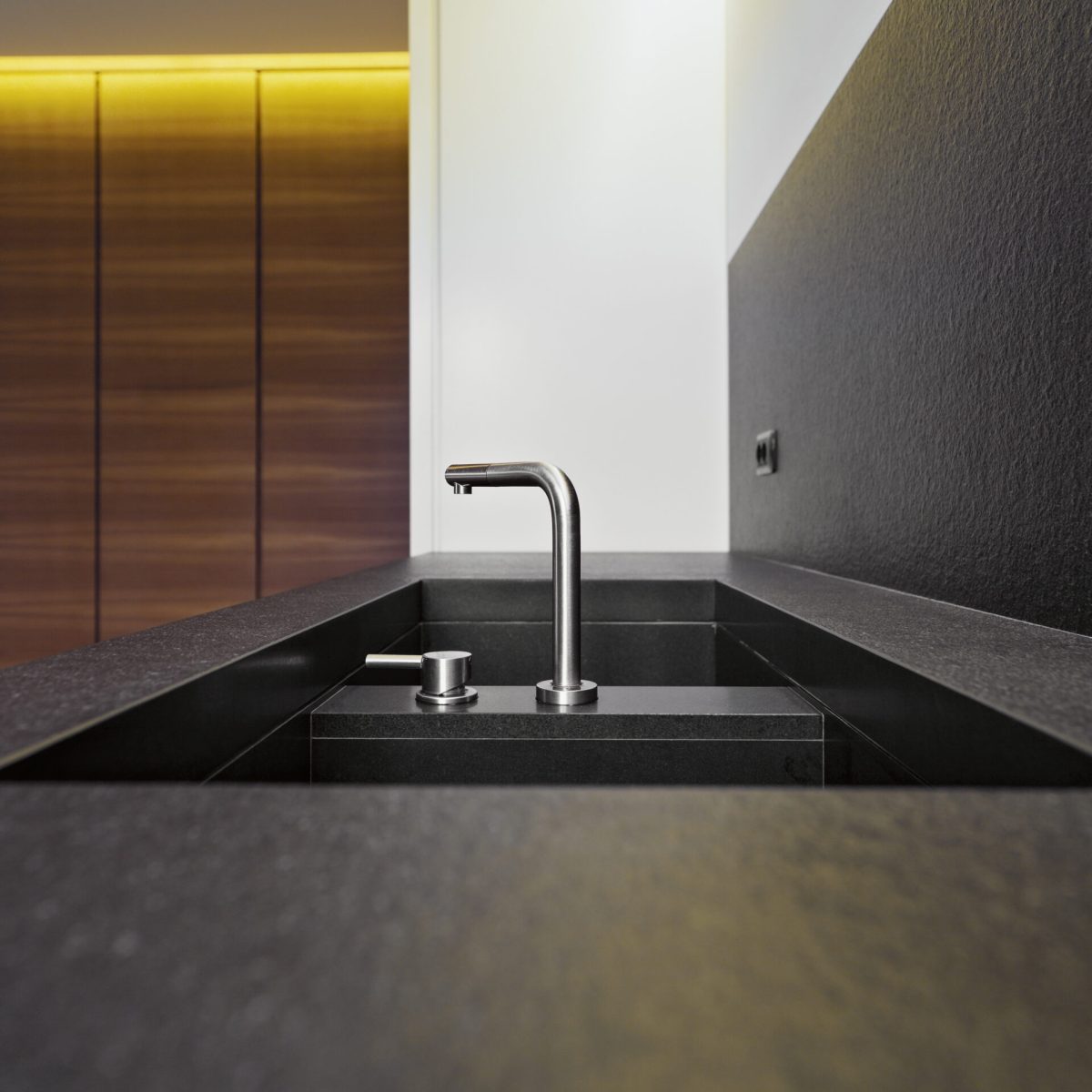 detail of  steel tap fora a marble sink in a modern kitchen