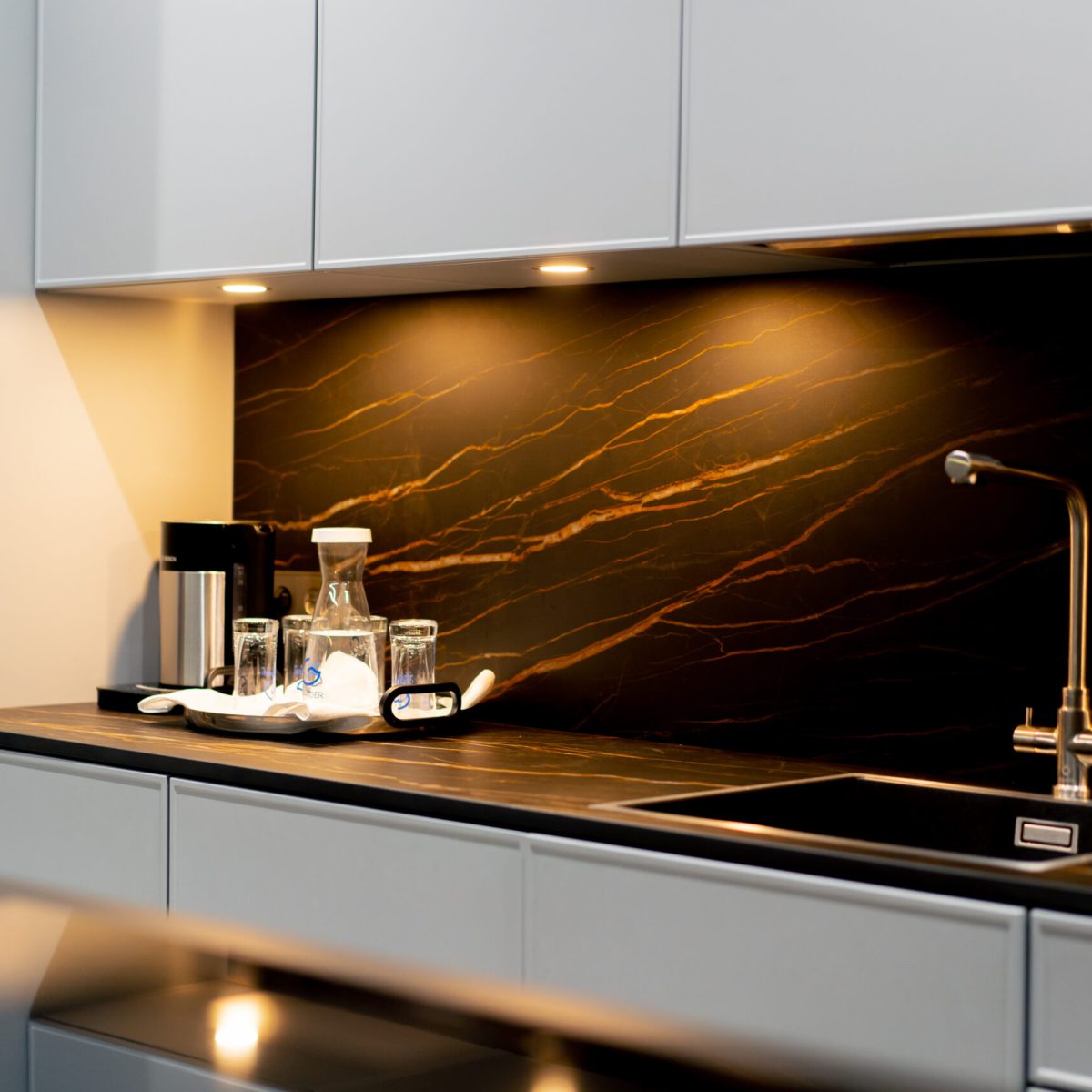 in a professional expensive kitchen, a view of the shelving unit and the area for preparing and washing food